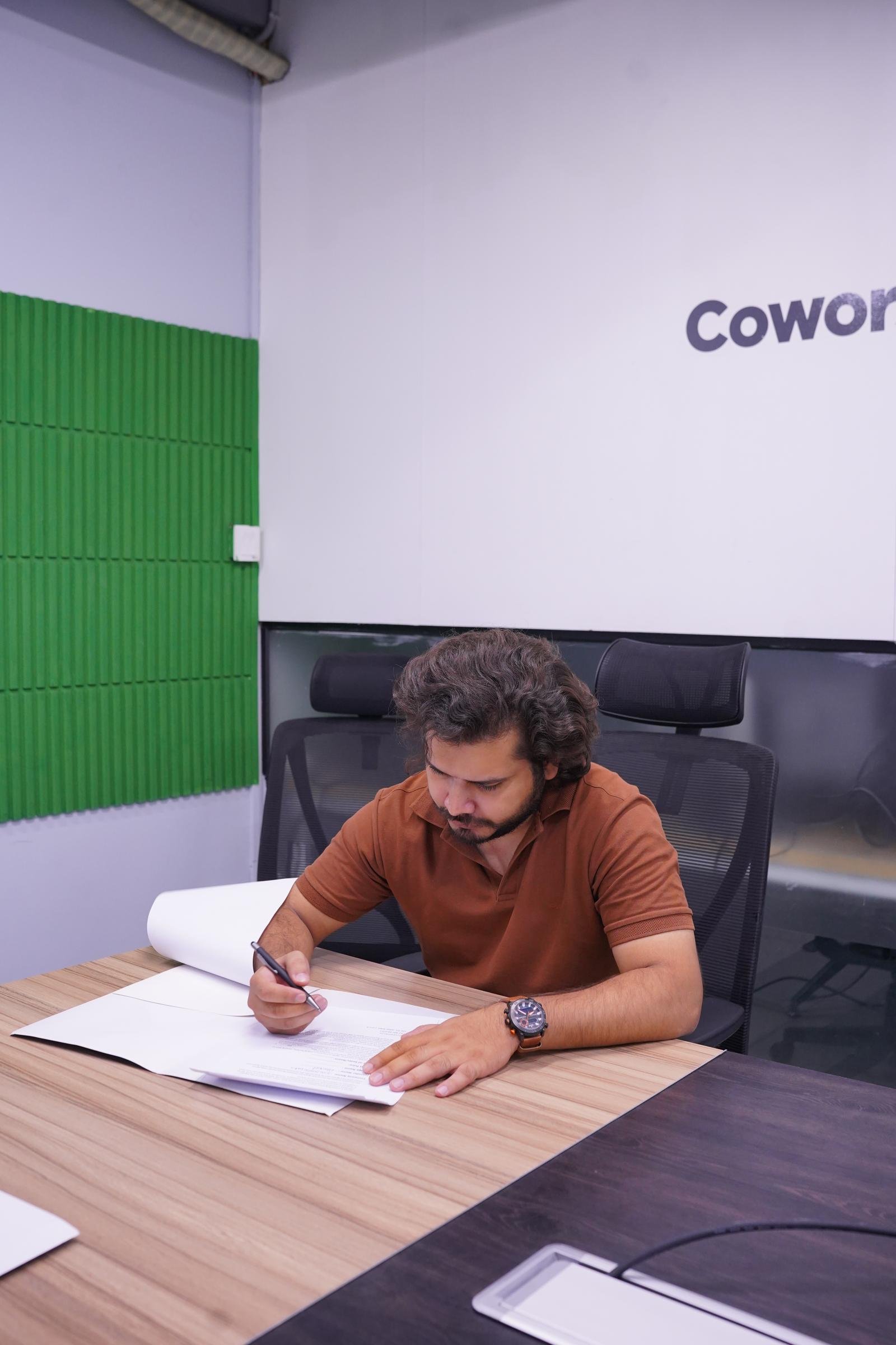 A WorkX member signing a coworking agreement in a meeting room