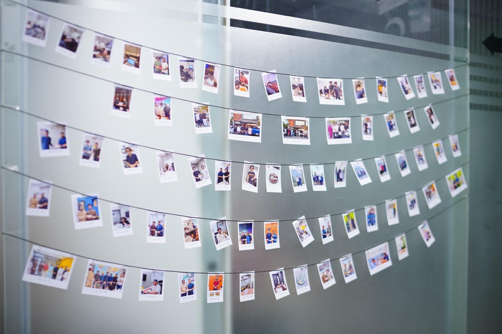 The WorkX community wall covered in member polaroid photos